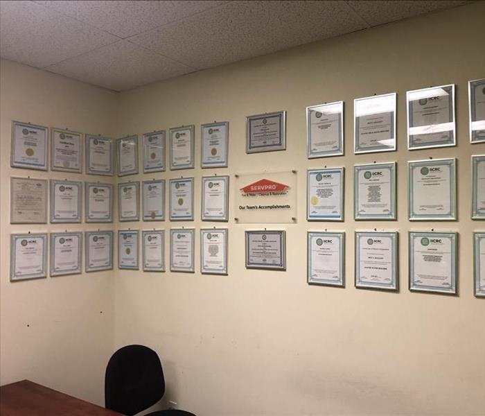 Many Plaques on wall showing IICRC certifications
